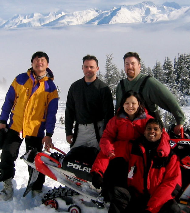 David Brodosi and friends traveling up mountin snow machine
