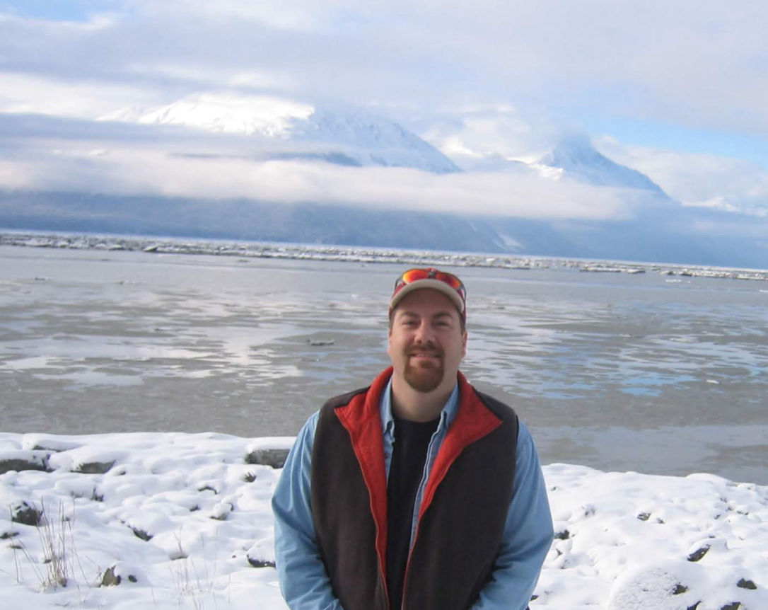 David Brodosi standing by the water in Alaska