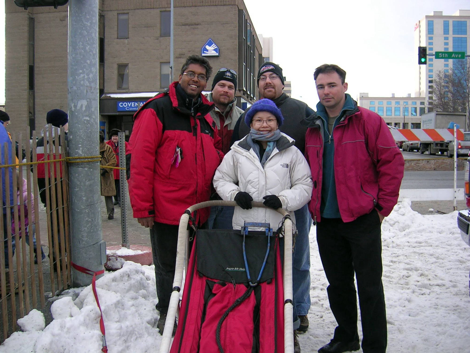 David Brodosi standing y dog sled in alaska